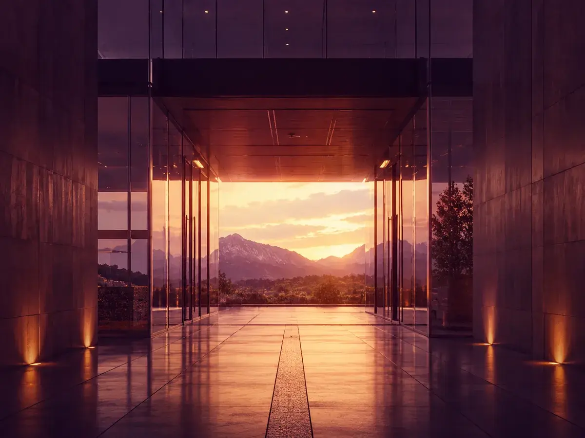 Glass doors opening onto a mountain sunset.